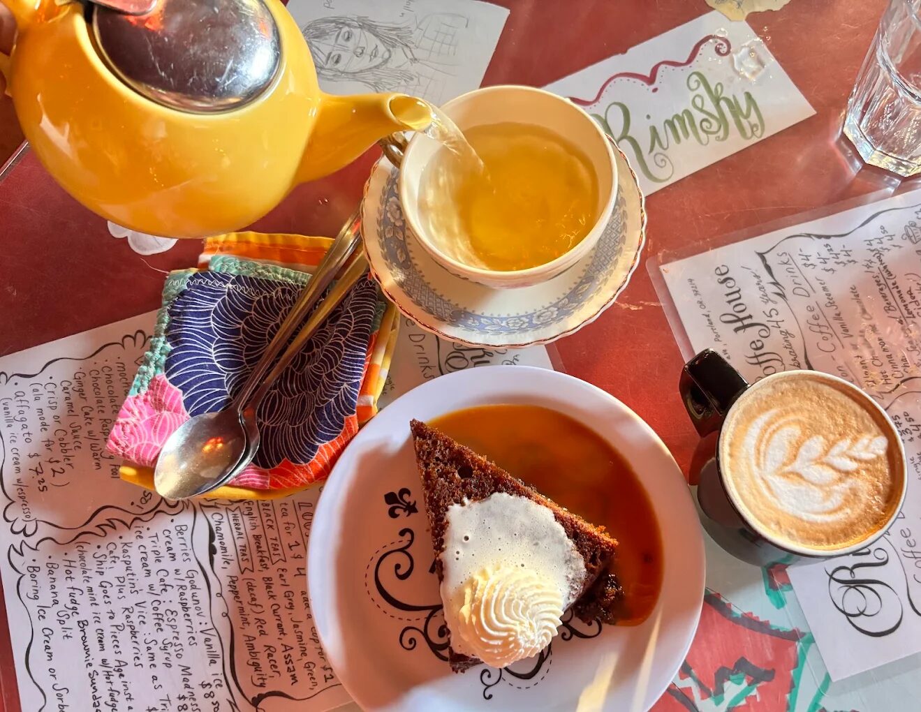 House-made dessert, tea, and latte art on a table at Rimsky-Korsakoffee House
