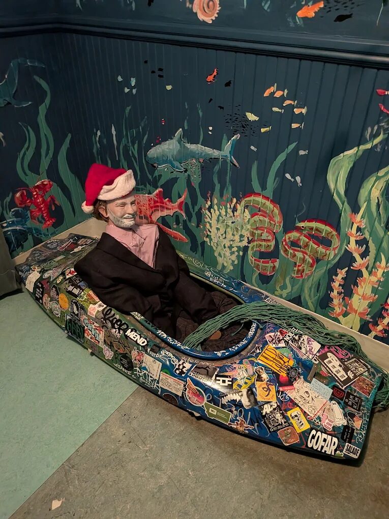One of the coffeehouse's quirky decor pieces in front of a hand-painted underwater mural